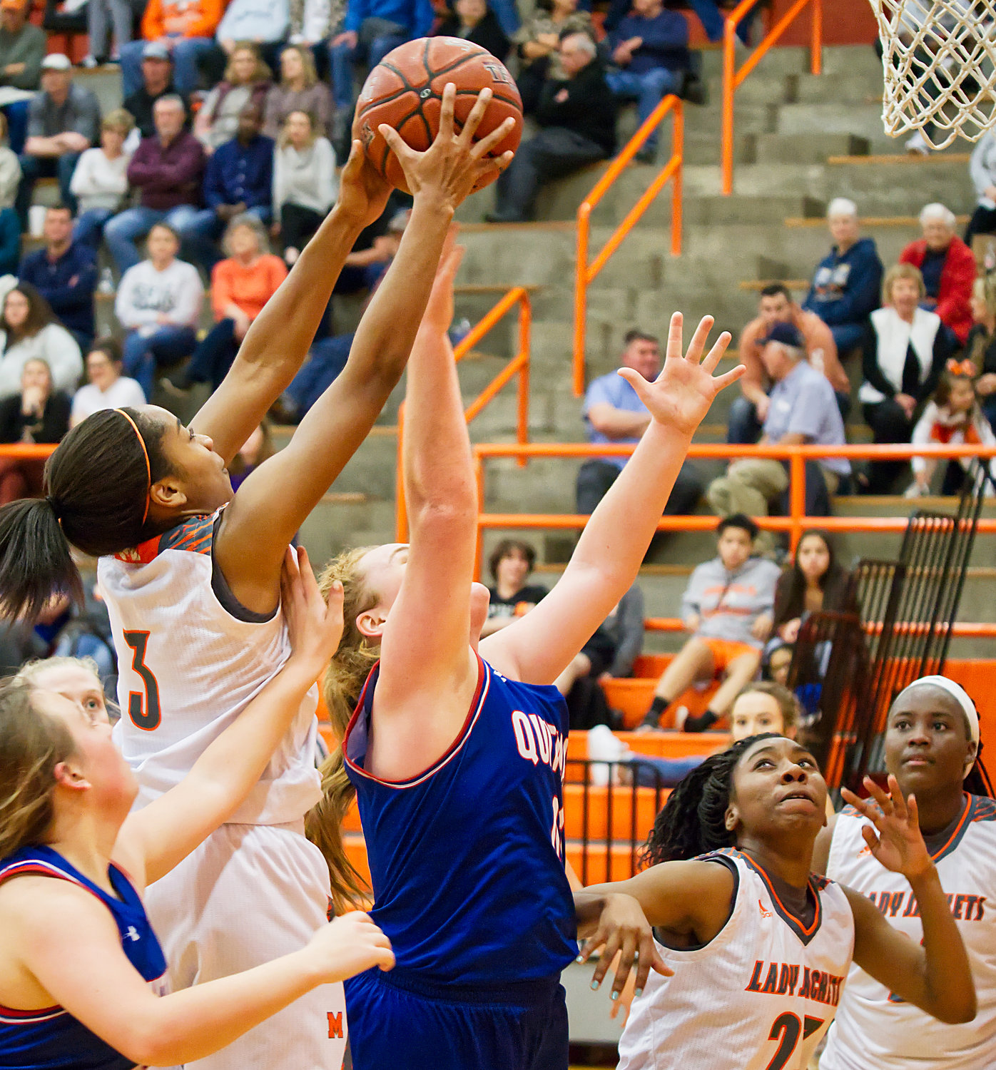 Mineola's Sabria Dean (3) skies for the board over Quitman post Reiny Luman.
